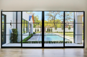 The living room at 112 Glenwood looks out onto the pool and inner garden.