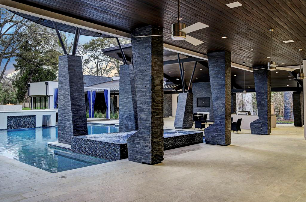 The pool and summer kitchen at 3 W. Rivercrest includes the requisite hot tub, by Custom Design Pools.