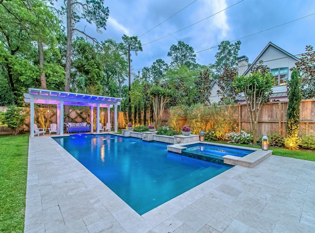 Figurehead side fountains provide movement in this pool setting, design by Custom Design Pools, at 11611 Windy Lane.