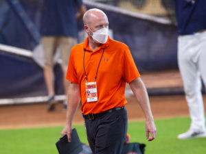 Houston Astros general manager James Click, with iPad in hand, watches a practice session at Minute Maid Park as Major League Baseball plans to start the 2020 season during the coronavirus pandemic