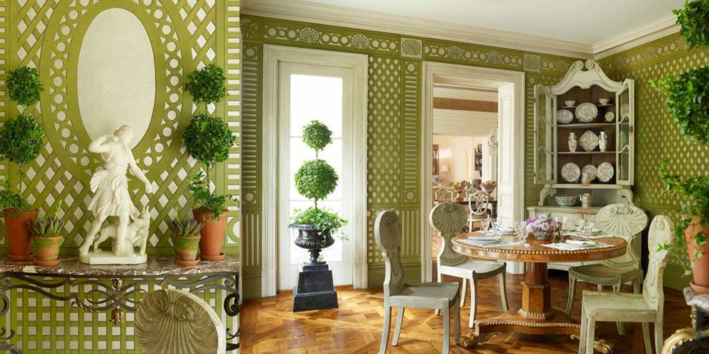 Custom Gracie wallpaper panels painted with green trellising over silver paper create the feeling of a mirrored, latticed room.