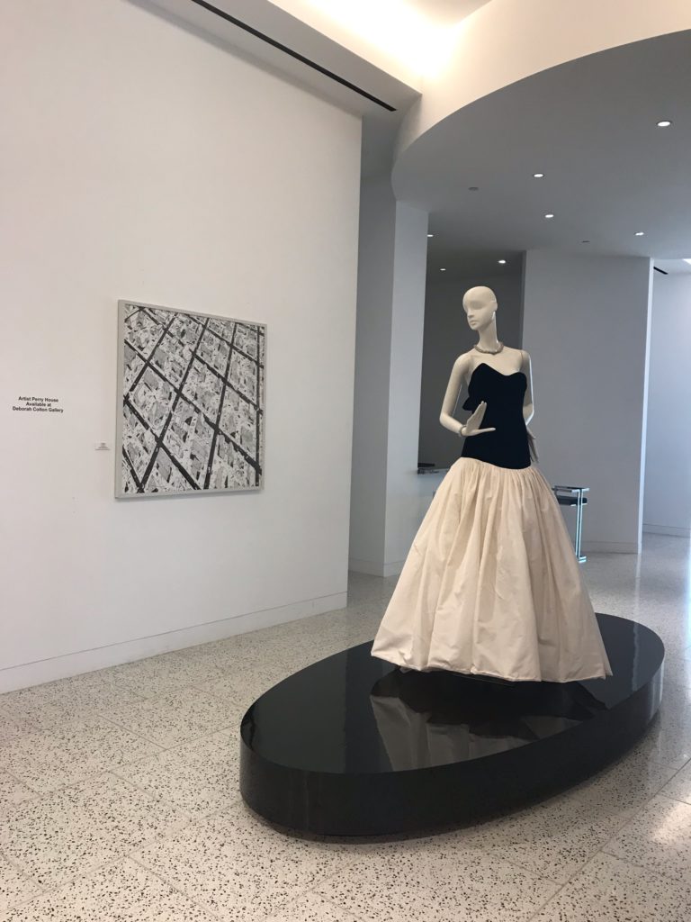 The late Houston painter Perry House is showcased at Tootsies through November 30. In this photo, a Monique Lhuillier ballgown dialogues with one of House’s elegant paintings. (Photo courtesy Tootsies and Deborah Colton Gallery)