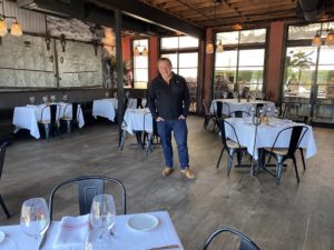 Ben Berg in the upstairs dining room at B&B Butchers where tables have been spread out for 25 percent occupancy. (Photo by Shelby Hodge)