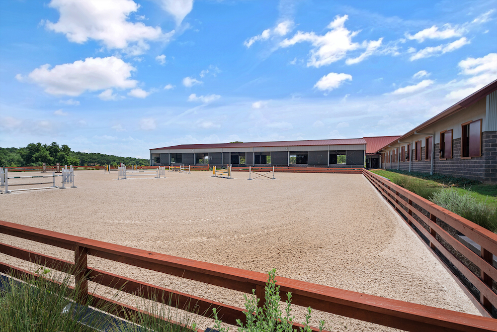 Beyond the barn, the grounds encompass four individual acre turnouts for horses to play and exercise. (Photo by Zach Spross Photography for Douglas Elliman)