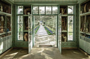 Inside the central pavilion of Bunny Mellon’s formal greenhouse at Oak Spring with Fernand Renard trompe l’oeil paintings.
