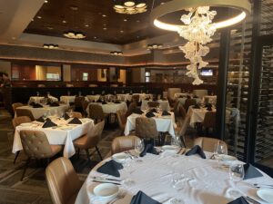 The Woodlands Fleming’s floral chandelier adds to the Texas feel, next to the new glass wine area.