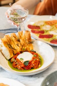 Emelia’s – Starters include burrata with roasted tomato jam and a carpaccio trio of tuna, salmon and scallops.