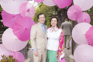Beds – Russ Fleischer and Liz Fleischer surrounded by pink parasols.