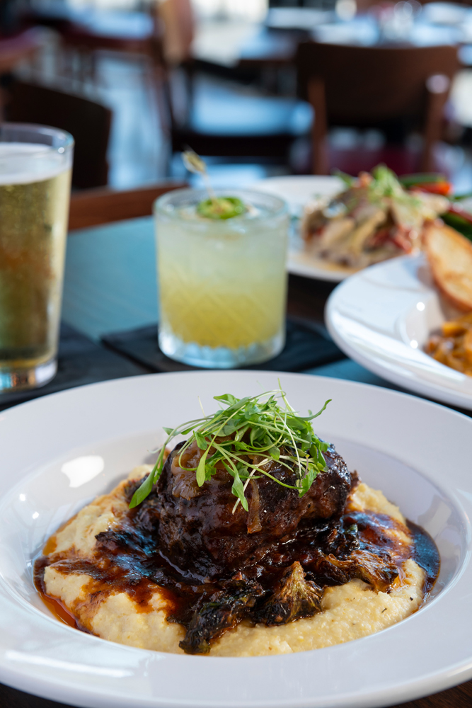 Hearsay's Beef Short Rib, braised in Shiner Bock for a flavorful taste, is served with caramelized onions, creamy cheddar grits, and bacon Brussels sprouts.
 (Photo by Anthony Rathbun)