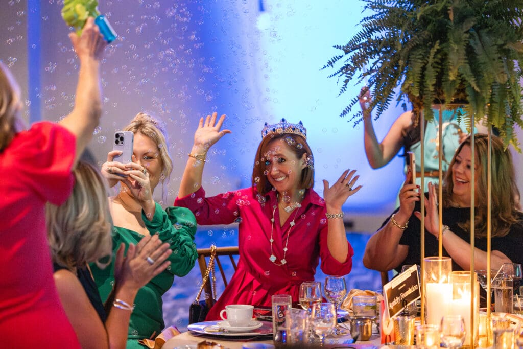 Auction winners were celebrated with bubbles and a crown. (Photo courtesy of TWCA)