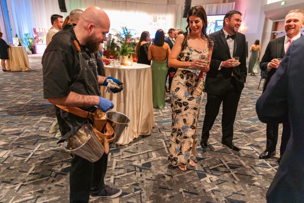 A live oyster shucker kept cocktail hour lively. (Photo courtesy of TWCA)
